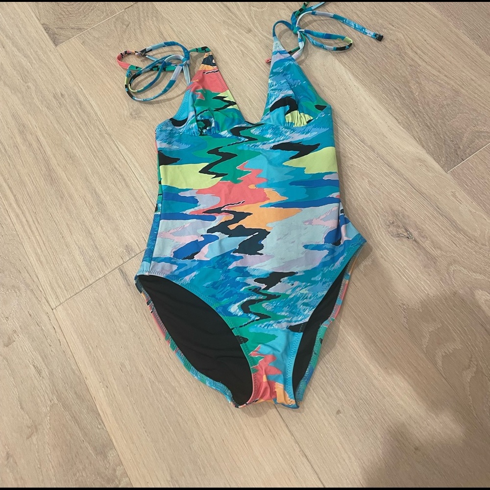 Solid and stripped The Olympia one piece bathing suit.